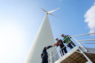 Technician in front of wind turbine