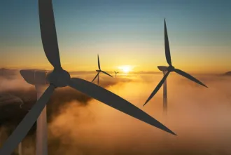 Wind turbine silhouette at sunrise